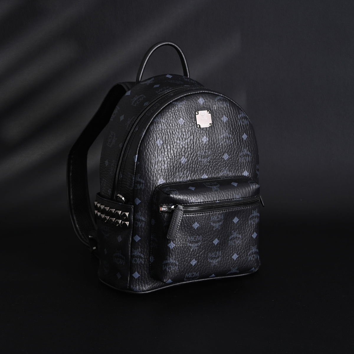 MCM Stark Visetos Medium Backpack – Black Monogram with Studded Detailing