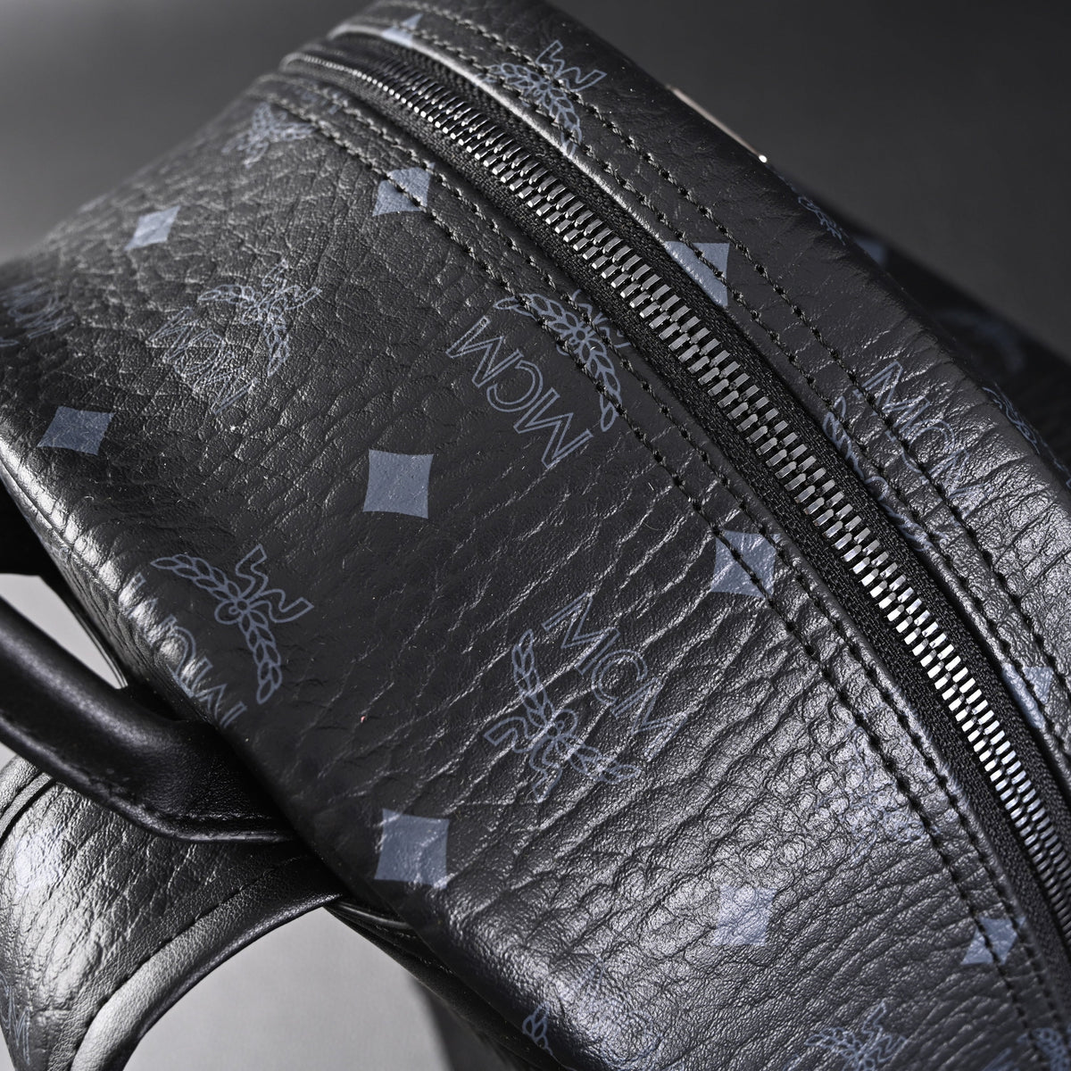 MCM Stark Visetos Medium Backpack – Black Monogram with Studded Detailing