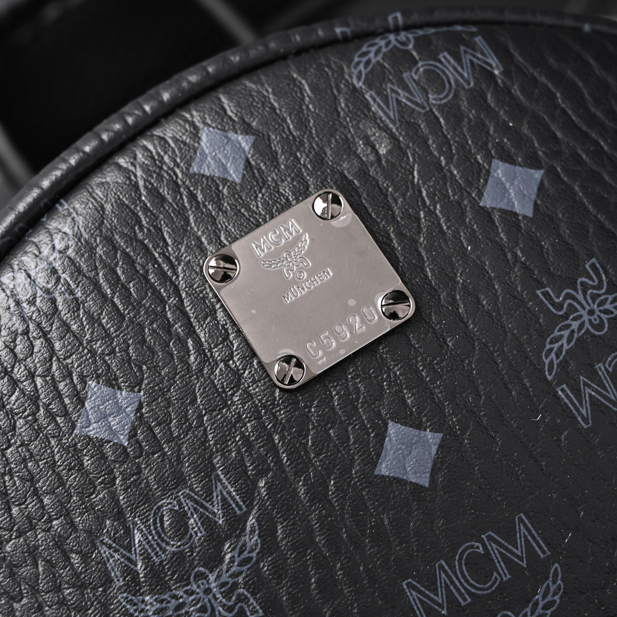 MCM Stark Visetos Medium Backpack – Black Monogram with Studded Detailing